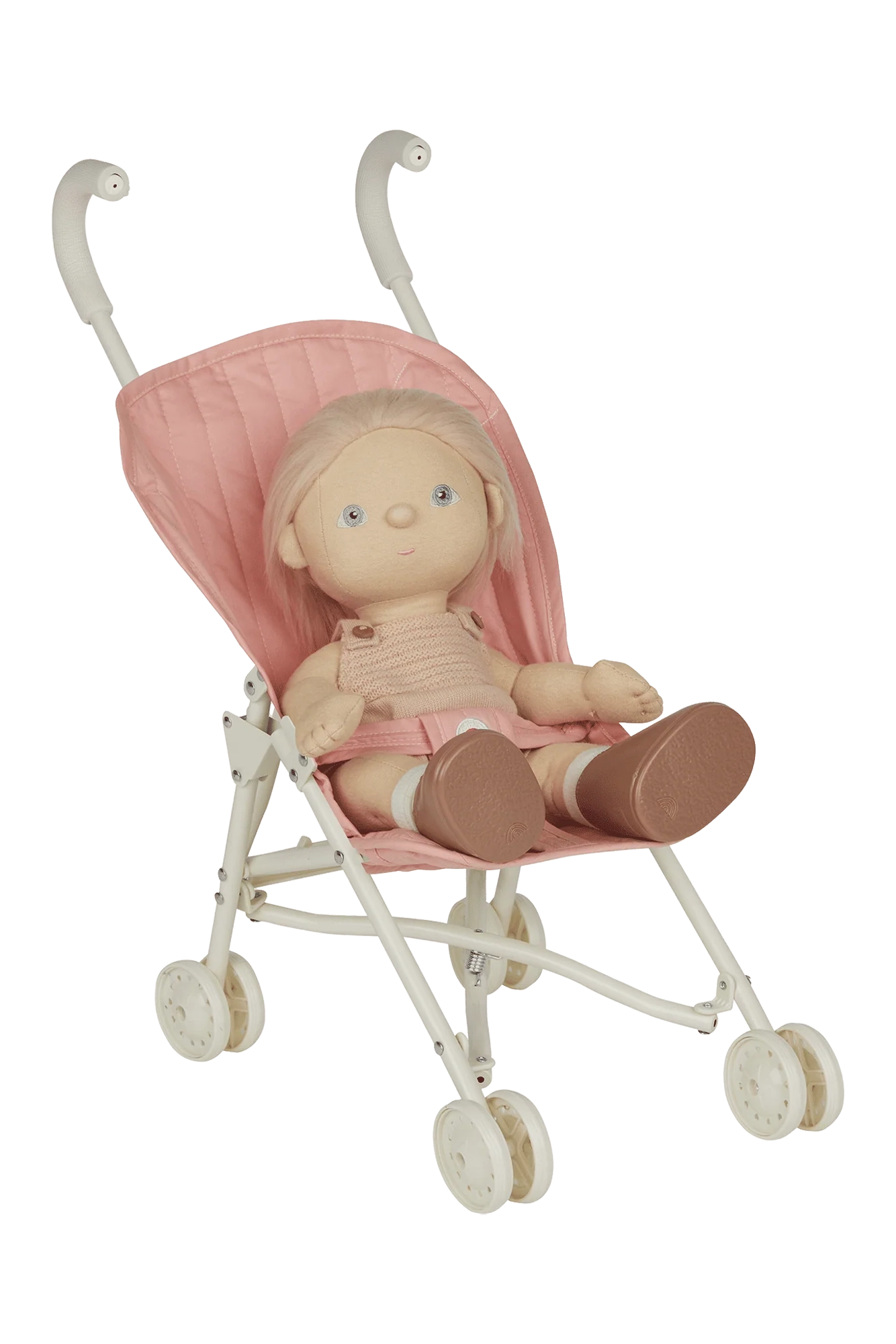 A doll with blonde hair sits in a Sollie Stroller Rose by OLLI ELLA, a compact, light pink kids' doll stroller featuring white wheels and frame. The doll is dressed in a knitted beige top and pink pants, accessorized with brown shoes.