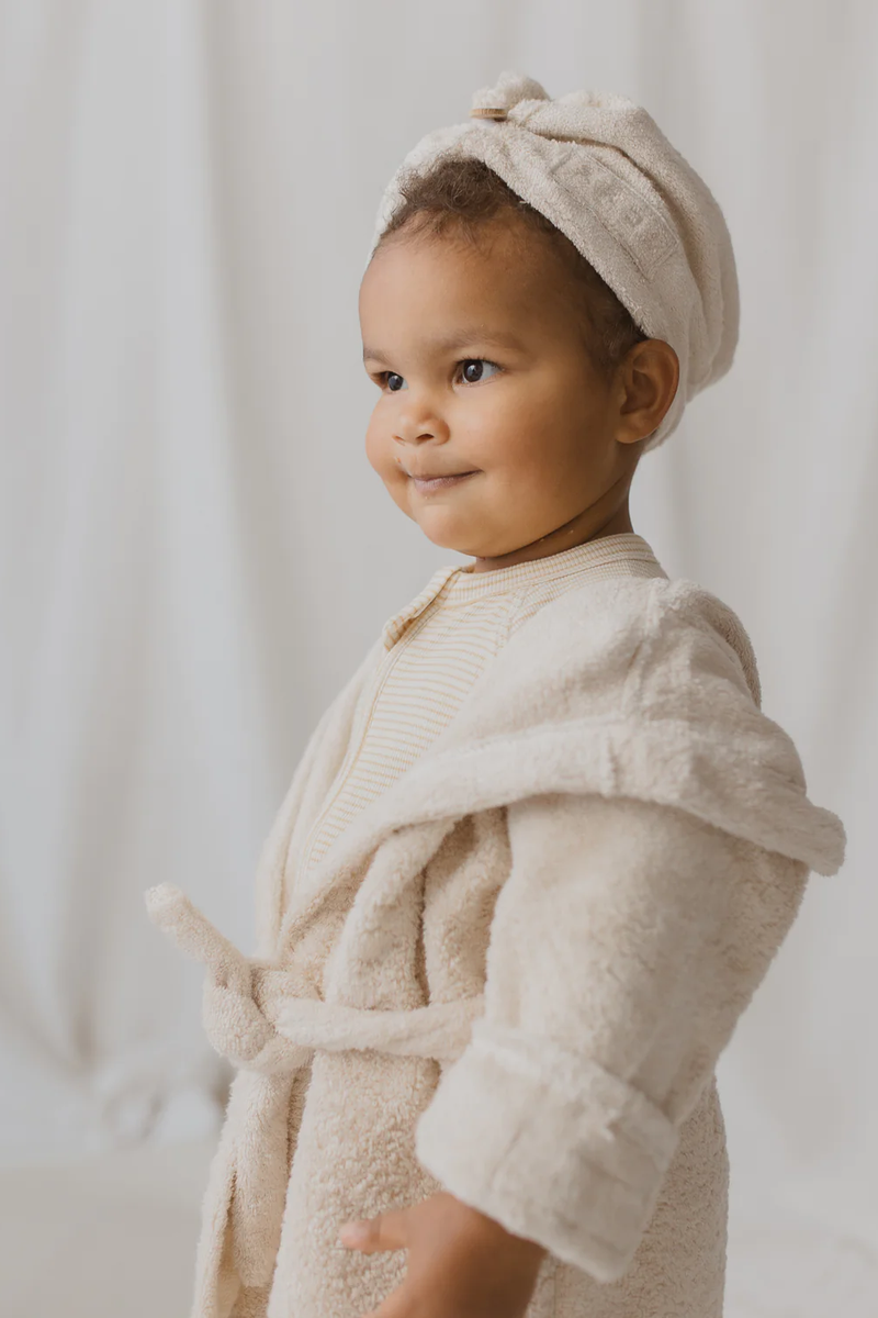 Little girl wearing towelling bath robe and hair towel