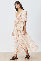Woman mid-stride wearing Alyona Dress in Anaelle Floral with cream crossbody bag
