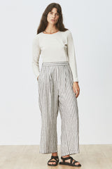 Front view of woman wearing Cora Tee in Cream Marle with striped pants