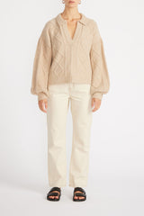 Front view of woman wearing Norma Collared Jumper in Natural with cream jeans