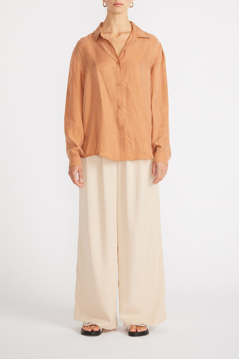 Front view of woman wearing Elsie Cupro Shirt with wide leg pants.