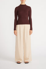 Front view of woman wearing Kaia Knit Skivvy with wide leg pants.