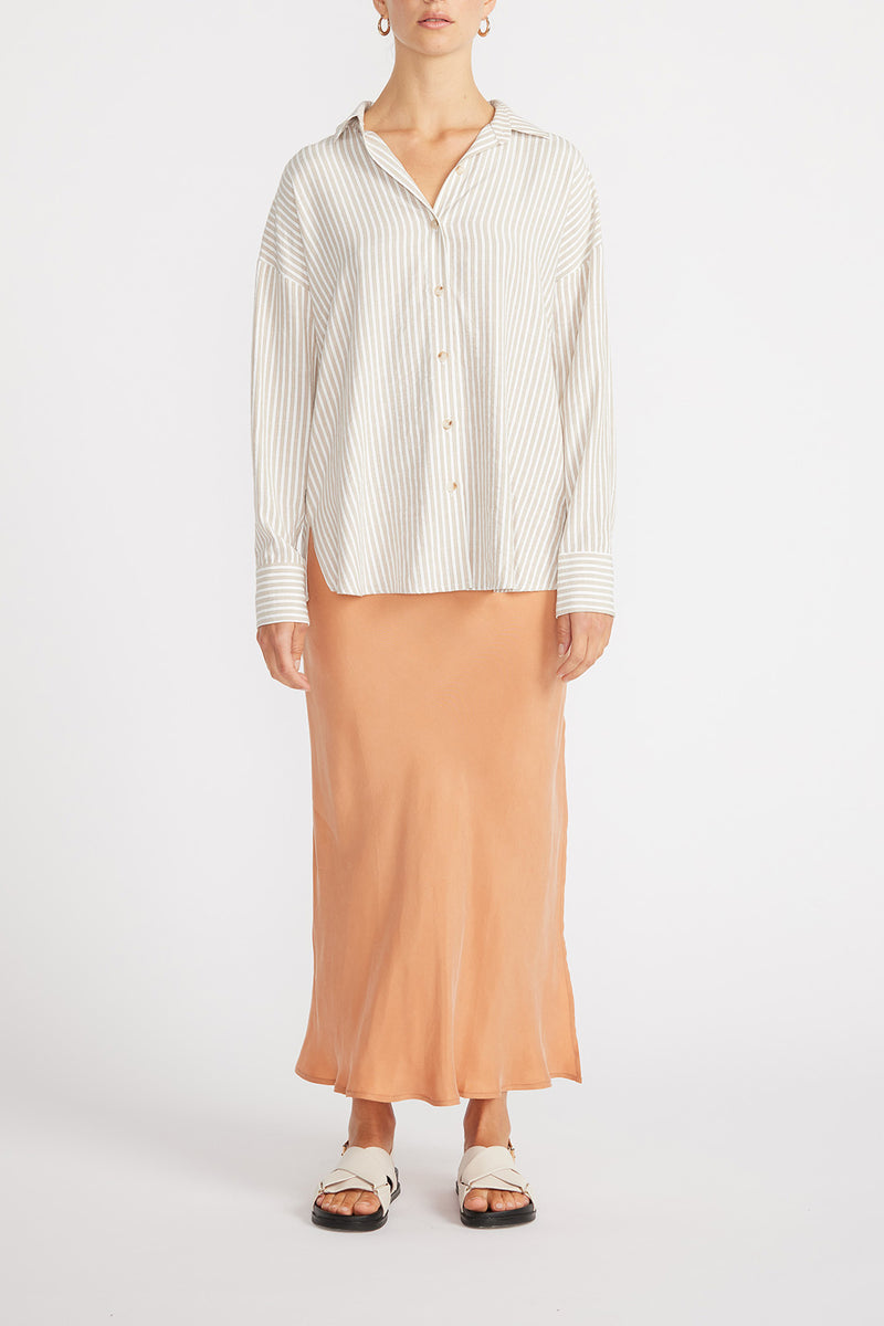 Front view of woman wearing Maya Oversized Shirt with slip skirt.