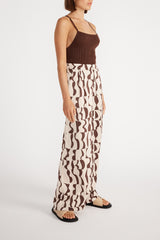 Side view of woman wearing Muse Wide Leg Pant with brown cami.