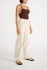 Side view of woman wearing Kinsley Wide Leg Jean with a brown cami.