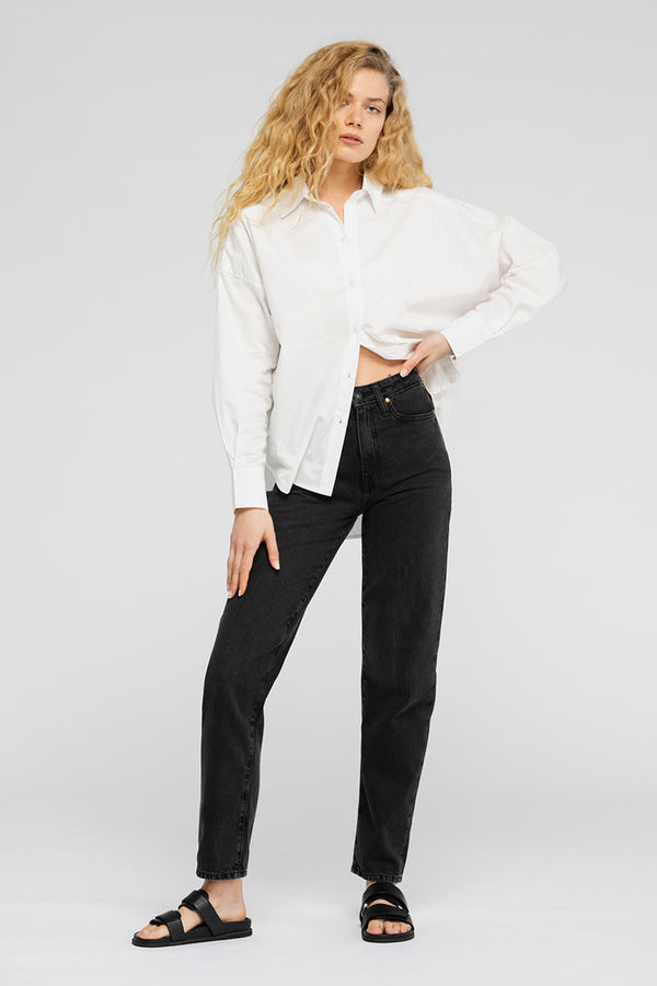 Woman in white shirt and black jeans