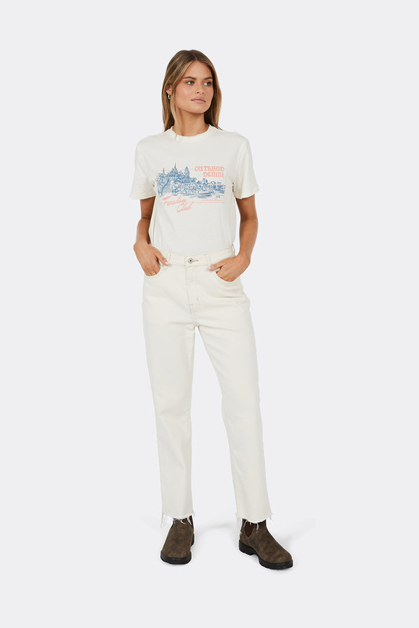 Woman wearing white printed t-shirt and cream jeans